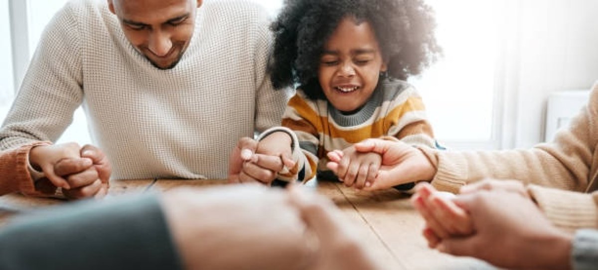 family holding hands and praying